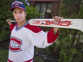 Daniel Kozel with his Cary Price stick outside his Montreal home on May 21, 2018. Kozel is one of the many young Montreal Canadiens fans who are too young to remember Habs' last Cup win 25 years ago.