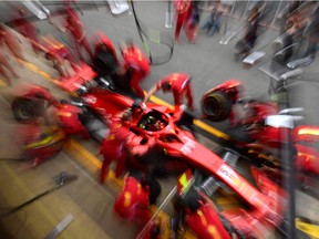 Ferrari pit crew get to work on Sebastian Vettel's car during Friday practice for the Spanish Grand Prix at the Circuit de Barcelona-Catalunya.
