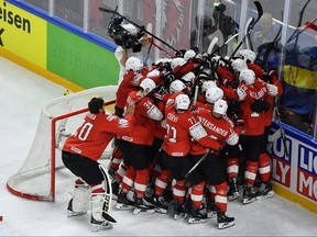 Switzerland's players celebrate after the semifinal match Canada vs Switzerland of the 2018 IIHF Ice Hockey World Championship at the Royal Arena in Copenhagen on Saturday, May 19,