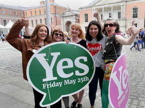 Yes campaigners jubilate as they wait for the official result of the Irish abortion referendum, at Dublin Castle in Dublin on May 26, 2018.  The first official results declared in Ireland's historic referendum on its strict abortion laws, showed 60 percent in the Galway East constituency backed repealing the constitutional ban on terminations.