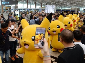 Fans gathering to watch the Pokemon Go virtual reality game mascot Pikachu parade during a promotional event in 2016.