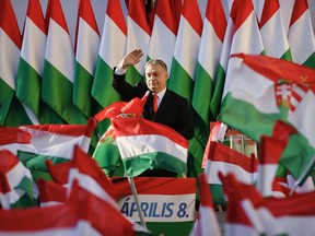 Prime Minister Viktor Orban's waves during the final electoral rally of his Fidesz party in Szekesfehervar, Hungary, Friday, April 6, 2018. Hungarians will vote Sunday in parliamentary elections, choosing 199 lawmakers and polls expect Prime Minister Viktor Orban to win a third consecutive term and his fourth overall since 1998.(AP Photo/Darko Vojinovic) ORG XMIT: XVG122