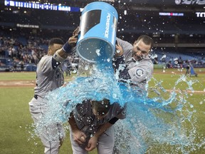 Seattle Mariners starting pitcher James Paxton, from Ladner, B.C., is hit with gatorade by teammates Robinson Cano and Mike Zunino after he pitched a no-hitter against the Toronto Blue Jays in American League MLB baseball actionin Toronto on Tuesday May 8, 2018.