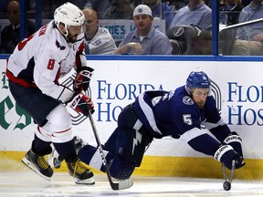 Dan Girardi of the Tampa Bay Lightning dives for the puck against Alex Ovechkin of the Washington Capitals at Amalie Arena on May 11, 2018 in Tampa. (Bruce Bennett/Getty Images)