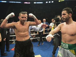 David Lemieux, of Montreal, left, celebrates his victory as Karim Achour, of France, looks on, at the end of a Middleweight fight, Saturday, May 26, 2018 in Quebec City.