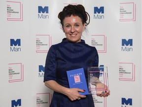 Polish author Olga Tokarczuk smiles after winning the Man Booker International prize 2018, Tuesday, May 22, 2018, for her book Flights, at the Victoria and Albert Museum in London.