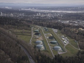This Nov. 25, 2016 photo shows the Kinder Morgan Inc. oil storage facility in Burnaby, Canada. Prime Minister Justin Trudeau's government approved the expansion of the Trans Mountain pipeline, arguing that it was "economically necessary" and enabled him to overcome opposition to a carbon tax plan that will help Canada cut its greenhouse emissions. (Jonathan Hayward/The Canadian Press via AP) ORG XMIT: CPT505