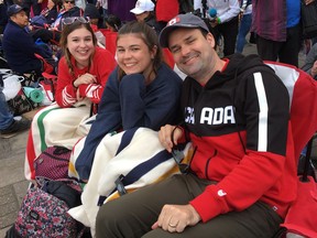 Pat Hart, right to left, poses with his daughters Camille and Charlotte as they camp along the procession route near Windsor Castle in Windsor, England, on Friday, May 18, 2018 ahead of Prince Harry's wedding to Meghan Markle on Saturday.