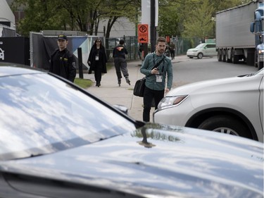 MONTREAL, QUE.: MAY 23, 2018-- A pedestrian is forced to stop and wait as cars enter and exit the valet parking zone during the C2 event in Montreal on Wednesday May 23, 2018. Two pedestrians narrowly avoided being struck by vehicles while a Gazette photographer was on the scene. (Allen McInnis / MONTREAL GAZETTE) ORG XMIT: 60727