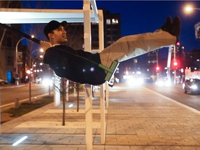 Dax Methot, visiting from Toronto, enjoys the 21 Swings art installation by Montreal designers Mouna Andraos and Melissa Mongiat in Place des Arts on Saturday, March 30, 2011.