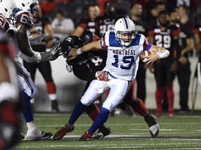 Montreal Alouettes quarterback Garrett Fugate gets tackled by the Ottawa Redblacks during second half CFL pre-season action in Ottawa on Thursday, May 31, 2018.