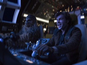 In this image released by Lucasfilm, Alden Ehrenreich, right, and Joonas Suotamo appear in a scene from "Solo: A Star Wars Story."