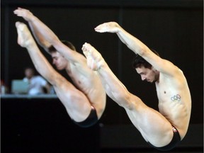 Philippe Gagne and Francois Imbeau-Dulac of Canada perform a dive in the men's open 3m synchro dive finals in Gatineau, Quebec, Canada, Saturday May 3, 2014.