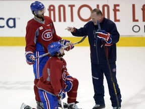 Former Montreal Canadiens assistant coach Gerard Gallant speaks with Max Pacioretty, top, and David Desharnais during a practice on May 7, 2014, in Brossard.