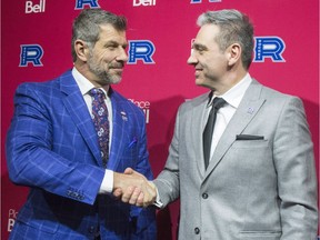 New Laval Rocket new head coach Joel Bouchard (right) shakes hands with Canadiens general manager Marc Bergevin after a news conference on May 17, 2018 at Place Bell in Laval.