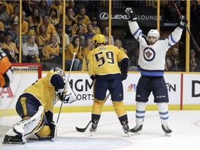 Winnipeg Jets centre Paul Stastny, right, celebrates after teammate Tyler Myers, not shown, scored a goal against Nashville Predators goalie Pekka Rinne, left, of Finland, during the first period in Game 7 of an NHL hockey second-round playoff series Thursday, May 10, 2018, in Nashville, Tenn. Also defending for the Predators is Roman Josi (59), of Switzerland.