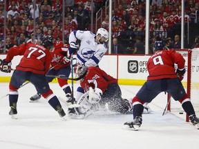 Tampa Bay Lightning left wing Alex Killorn (17) scores on Washington Capitals goaltender Braden Holtby (70) during the third period of Game 4 of the NHL hockey Eastern Conference finals Thursday, May 17, 2018, in Washington. Also on the ice for the Capitals are right wing T.J. Oshie (77) and defencemen John Carlson and Dmitry Orlov (9).