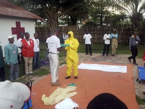 In this photo taken Monday, May 14, 2018, members of a Red Cross team don protective clothing before heading out to look for suspected victims of Ebola, in Mbandaka, Congo. Congo's Ebola outbreak has spread to Mbandaka, a crossroads city of more than 1 million people, in a troubling turn that marks one of the few times the vast, impoverished country has encountered the lethal virus in an urban area.
