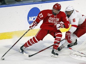 Boston's Brady Tkachuk handles the puck against Cornell's Alex Green during the first period of an NCAA regional tournament game in Worcester, Mass., on March 24, 2018.