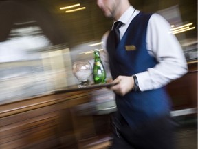 A waiter works in a French brasserie "Le Train Bleu", on April 11, 2013 in Paris. AFP PHOTO / FRED DUFOUR