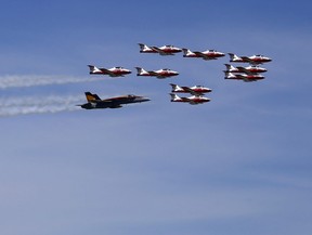 The Royal Canadian Air Force's CF-18 Hornet demonstration fighter jet, piloted by Capt. Ryan Kean, flies in formation with the CT-114 Tutor jets of the Snowbirds team over CFB Trenton, Ont. Thursday, June 23, 2016.