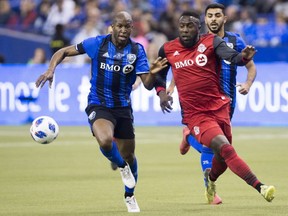 Montreal Impact defender Rod Fanni, left, challenges Toronto FC forward Jozy Altidore, during MLS action in Montreal on March 17, 2018.