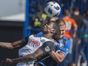 Impact's Samuel Piette, right, and Philadelphia Union's Cory Burke battle to head the ball during first half MLS action in Montreal on Saturday, May 12, 2018.