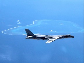 FILE - In this undated file photo released by Xinhua News Agency, a Chinese H-6K bomber patrols the islands and reefs in the South China Sea. The China Daily newspaper reported Saturday, May 19, 2018 that People's Liberation Army Air Force conducted takeoff and landing training with the H-6K bomber in the South China Sea. (Liu Rui/Xinhua via AP, File) ORG XMIT: TKMY101
