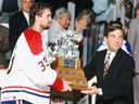 Montreal Canadiens' Patrick Roy accepts Conn Smythe Trophy from NHL commissioner Gary Bettman at the Montreal Forum on June 9, 1993.