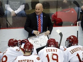 University of Denver head coach Jim Montgomery directs his players during a time-out. Montgomery has been named the Dallas Stars' new head coach.