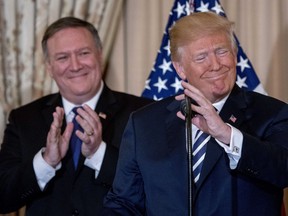 President Donald Trump, accompanied by Secretary of State Mike Pompeo, speaks during a ceremonial swearing in for Pompeo at the State Department, Wednesday, May 2, 2018, in Washington.