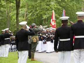 U.S. Marines salute as they participate in a commemoration at the American Marine Memorial in Belleau Wood prior to a service at the Aisne-Marne American Cemetery in Belleau, France, Sunday, May 27, 2018.