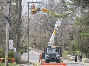 A Hydro-Québec crew works on restoring power in the town of Hudson, west of Montreal, Saturday, May 5, 2018, following a storm in Quebec and parts of Ontario.