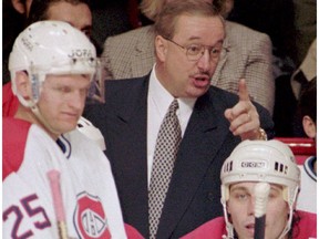 Canadiens' Vincent Damphousse, left, and Lyle Odelein look on as head coach Jacques Demers talks to players on the bench during his team's 1992-93 Stanley Cup championship season.