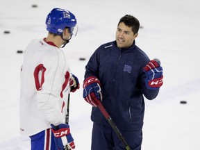 Laval Rockets defenceman Noah Juulsen speaks with Francis Bouillon during a team practice in Montreal in January.