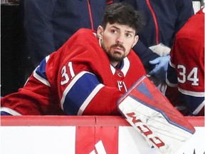 Canadiens goalie Carey Price sits on the bench backing up starter Antti Niemi during NHL game against        the Florida Panthers at the Bell Centre in Montreal on March 19, 2018.