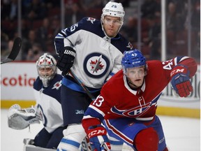 Canadiens' Daniel Carr loses his balance after being pushed by Winnipeg Jets centre Paul Stastny in Montreal on April 3, 2018.