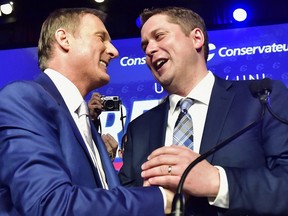 Andrew Scheer, right, is congratulated by Maxime Bernier after being elected the new leader of the federal Conservative party at the federal Conservative leadership convention in Toronto on May 27, 2017.