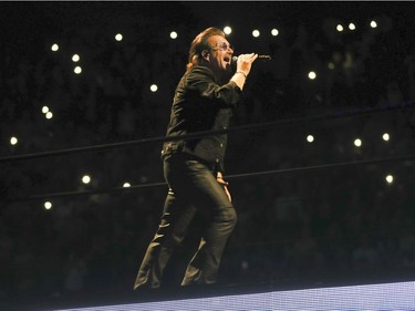 Bono climbs the catwalk during U2 concert at the Bell Centre in Montreal Tuesday June 5, 2018.