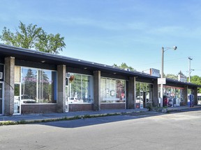 A developer wants to build 24 townhouses on the site of the derelict Walton Ave. strip mall, pictured.