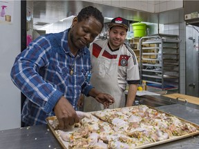 Community worker Howard Johnson recently gave a cooking class at the NDG Food Depot that featured a lesson on making jerk chicken. Joey Fontaine, a client of the Depot, looks on as Johnson checks the chicken before placing it in the oven to bake.