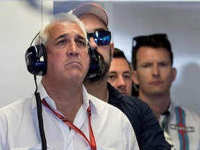 Lawrence Stroll, left, father of Williams Racing driver Lance Stroll, follows the action in the Williams garage during the morning practice round for the Canadian Formula 1 Grand Prix at Circuit Gilles Villeneuve in Montreal on June 10, 2017.