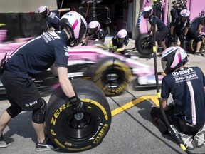 Mechanics practise tire changes in the Force India pits ahead of the Canadian Grand Prix at Circuit Gilles Villeneuve in Montreal on Thursday, June 7, 2018.