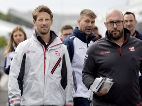 Stuart Morrison, right, escorts Haas driver Romain Grosjean of France to a Formula One event at Circuit Gilles Villeneuve in Montreal on Thursday, June 7, 2018.