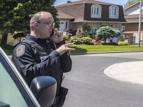 Longueuil police spokesperson Ghyslain Vallieres helps out in Brossard as cops gather info on a suspected stalker who has pursued at least four women in the area.