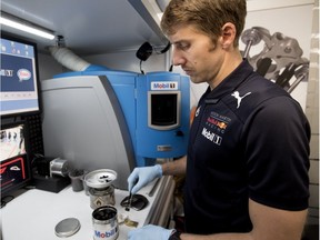 Dario Izzo, Mobil 1 track side analyst, checks a used engine oil sample in during practice rounds at the Canadian Grand Prix in Montreal on Friday, June 8, 2018.