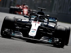 Mercedes driver Lewis Hamilton leads a Ferrari through the back section of Circuit Gilles Villeneuve  during practice rounds for the Canadian Grand Prix in Montreal on Friday, June 8, 2018.