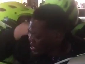 A frame from a  video posted on Facebook that shows a Montreal police officer pepper spraying a black man in the driver’s seat of a car and then being pulled from the vehicle as Grand Prix revellers thronged downtown sidewalks and roads on Saturday night.