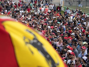 A crowd fills the start line area to watch the celebrations after Ferrari driver Sebastian Vettel (5) of Germany won the Canadian Grand Prix Formula 1 in Montreal on Sunday June 10, 2018.