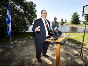 Longtime West Island MNA Geoff Kelley announces he won't be running in the upcoming provincial election, at a news conference on the shore of Lake Saint-Louis in Beaconsfield. Beaconsfield Mayor Georges Bourelle stands in the background.